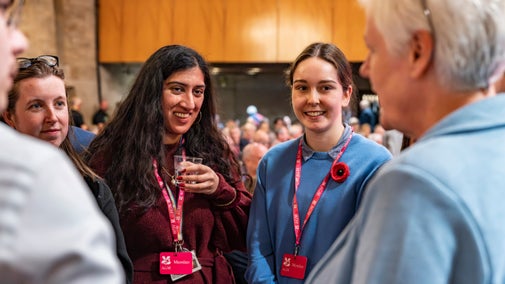 People smiling and chatting at the AGM 2024